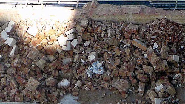 The grotesque lies amongst the rubble from the Regent Theatre.