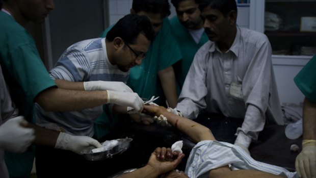 Pakistani doctors treat a boy injured by a suicide attack which killed 10 people.