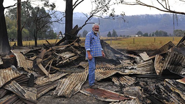 Graeme Beasley inspects his property damage in the town of Koornalla near Churchhill.