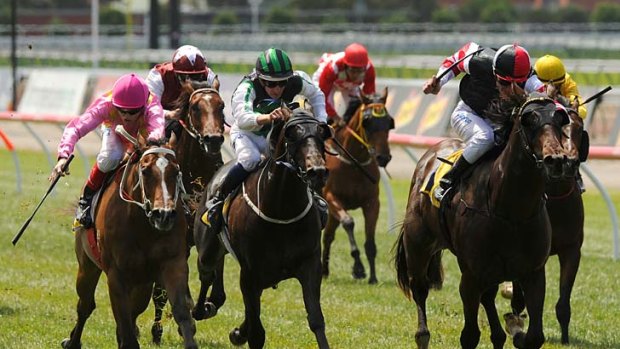 Direct Charge, ridden by Steve Arnold (right), wins the Maribyrnong Stakes from Crack A Rodie, (left) and Shamus Award (centre).