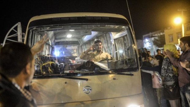 A driver in the Kurdish convoy salutes the welcoming crowds in Viransehir on October 30.