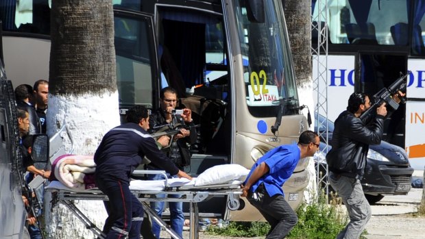 Rescue workers move an empty stretcher towards the museum.