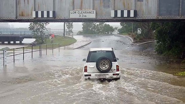 Flooded ... a motorist drives through water in Coffs Harbour.