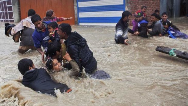 Kashmiris struggle against the strong current during the height of the flooding in Srinigar.