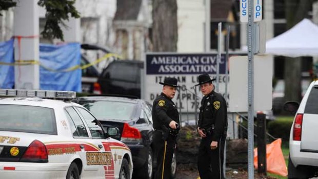 Investigators outside the American Civic Association building in New York state, where a gunman killed 13 people.