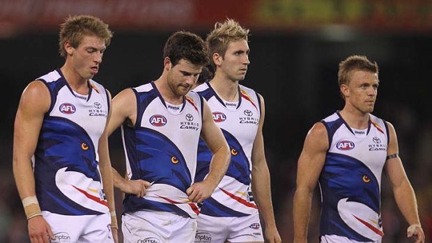 Crows players leave the crowd after being hammered by St Kilda.