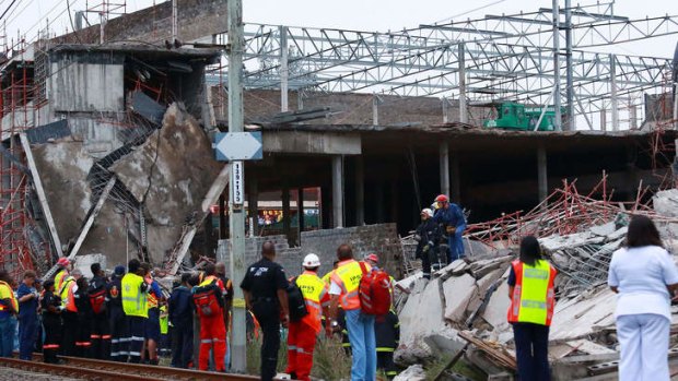 Rescuers search for  workers under the rubble at the Tongaat Mall, 40 kilometres north of Durban.