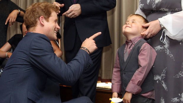 Don't say it ... Prince Harry wags his finger at Alex Logan.
