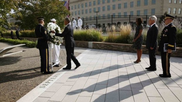 US President Barack Obama lays a wreath at the National 9/11 Pentagon Memorial during a ceremony marking the 13th anniversary of the 9/11 attacks at the Pentagon in Washington.