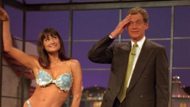 David Letterman reacts as actress Demi Moore poses in a bikini during taping of "Late Show With David Letterman," in 1995.