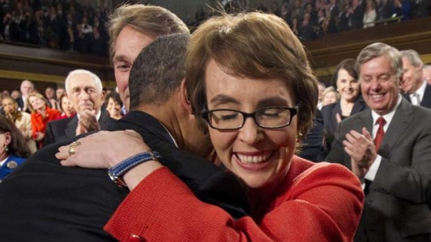 Colleagues in arms ... Barack Obama hugs Gabrielle Giffords, who is to leave Congress to recover after being shot last year.