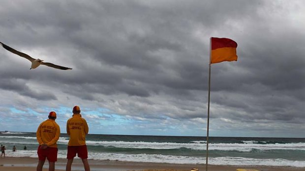 Flagging support... Adam Knight and Jonathan James keep watch at Bondi Beach on the last day of the volunteer surf life saving season yesterday.