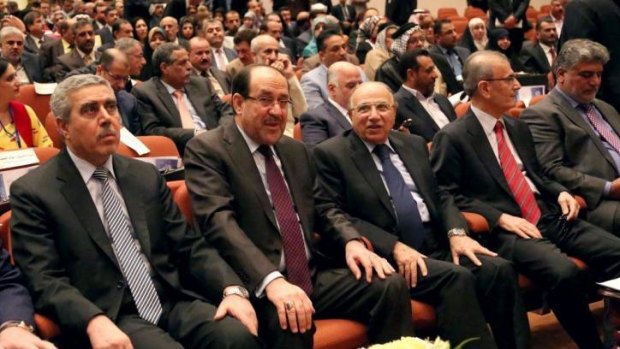 Iraq's Prime Minister Nouri al-Maliki, second left, attends the first session of parliament.