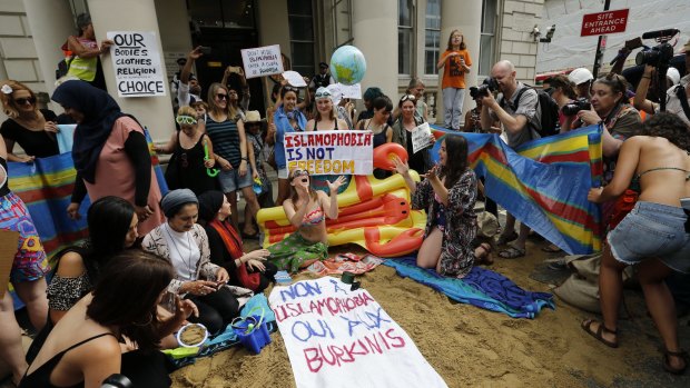 Activists protest the burkini ban outside the French embassy in London.