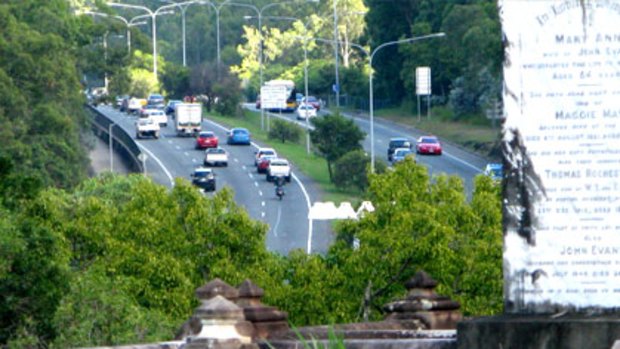 Traffic passes by the Toowong Cemetery.