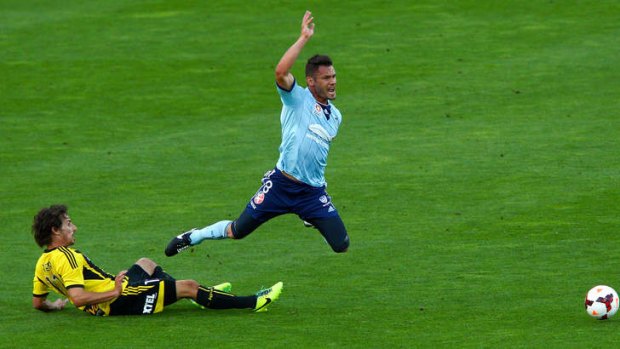 Theatrics: Sydney FC's Pedrag Bojic is tackled by Wellington's Albert Riera.