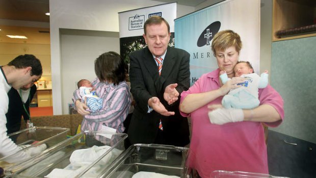 Then treasurer Peter Costello visiting babies born after he introduced the baby bonus scheme.