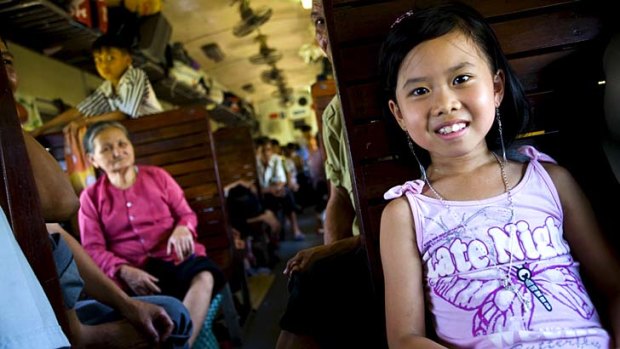 Hard seat ... a young girl on a train in Vietnam.
