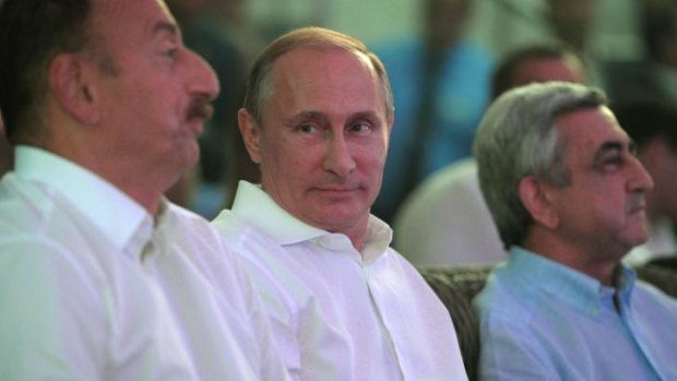 Russian President Vladimir Putin, centre, Azerbaijani President Ilham Aliev, left, and Armenian President Serge Sarkisian, right, attend a annual international tournament in combat sambo in the Black Sea resort of Sochi, Russia. 