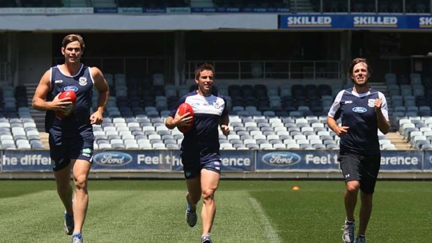 Cat attack: Aaron Baddeley (right) at Geelong training yesterday with Tom Hawkins and Shannon Byrnes.