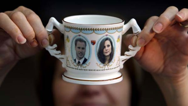 Guilder Lyn Holmes at Aynsley  China in Stoke-on-Trent, England, examines a "loving mug" to mark the engagement of William and Kate.