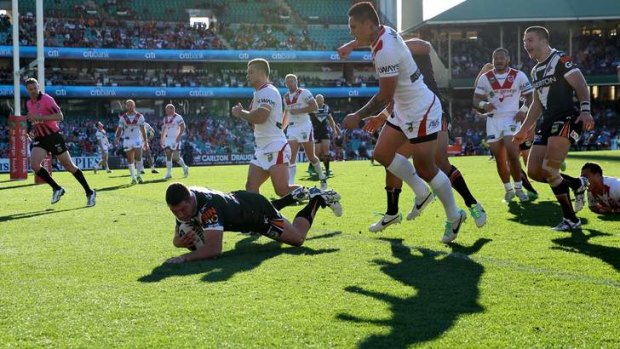Tigers Tigers burning bright: Curtis Sironen dives over to score during Wests' big win over St George Illawarra at the SCG on Saturday.
