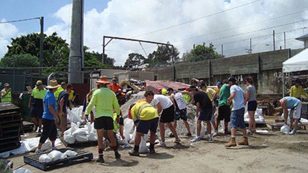 Volunteers prepare sandbags to be distributed to residents.