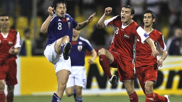 Japan's Daisuke Matsui (left) in action against Syria's Abdulfatah Al Aghaduring their AFC Asian Cup match in Doha.