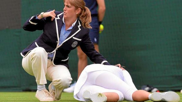 A Wimbledon staff member calls for help after Azarenka's fall.