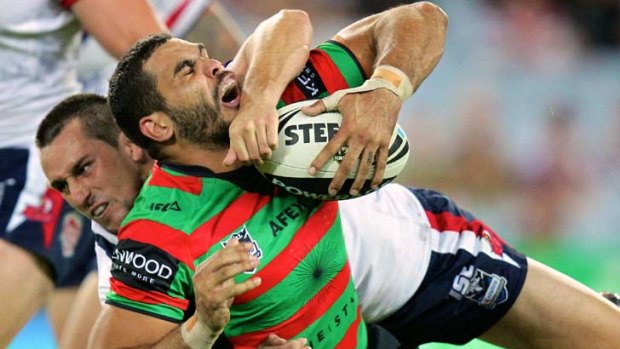 Brought down ... Mitchell Pearce drags Greg Inglis to the ground in last night's clash.