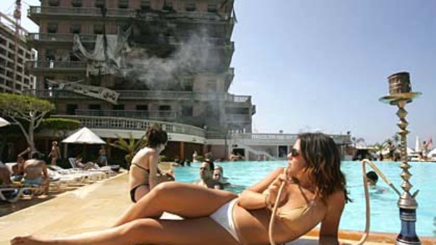 Rallying from devastation is typical of Beirut ... enjoying the pool of bombed landmark the Saint-Georges hotel.