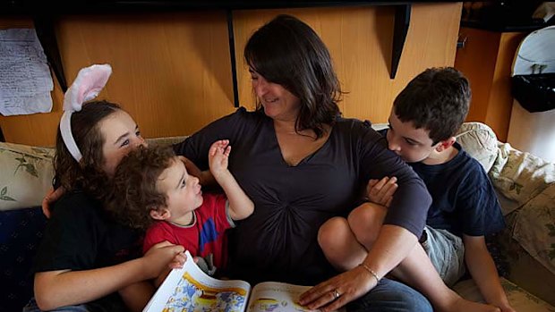 Non-religious Amanda Cox with her sons (from left) Matthew, 10, Charie, 2, and Jamie, 8, reading a Christmas story.