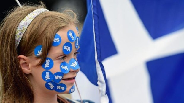 Scotland's future ... A young girl has yes stickers placed on her face in George Square, just a few hours before polling stations will close in the Scottish independence referendum in Glasgow, Scotland.