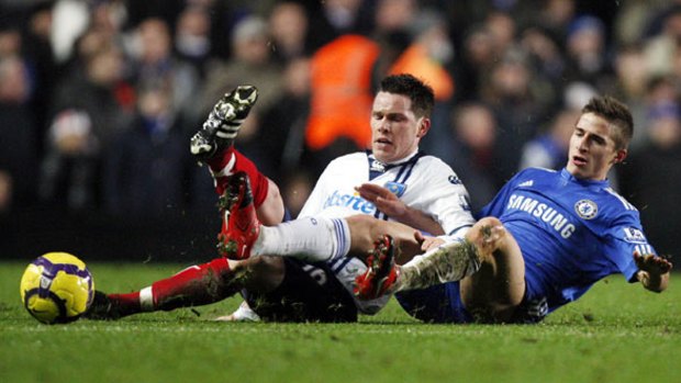 Bottom versus top . . . Portsmouth defender Steve Finnan slides in to dispossess young Chelsea striker Fabio Borini as the cellar dwellers gave the league leaders a run for their money on Wednesday.