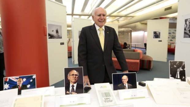 Former Prime Minister John Howard with some of his personal papers and Commonwealth records at the UNSW Canberra Academy Library.