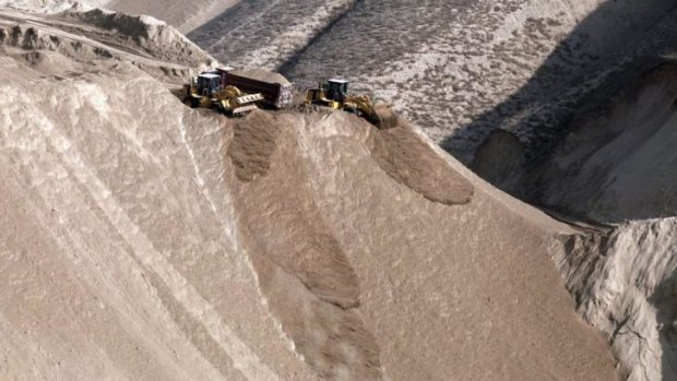 Chinese earth-movers shave off mountaintops in Lanzhou, Gansu province, to make way for cities.