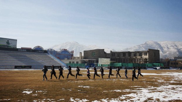 League of their own: The Afghan Women's Cricket team trains on a snow-covered Kabul Cricket Stadium in Afghanistan's capital.