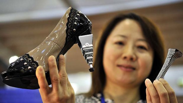 Taiwan's Juang Ying-Shen poses with her invention, interchangable high heels.