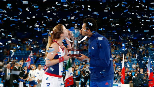 Alize Cornet and Jo-Wilfried Tsonga of France hold the Hopman Cup after defeating Grzegorz Panfil and Agnieszka Radwanska of Poland in the mixed doubles finals match of the Hopman Cup.