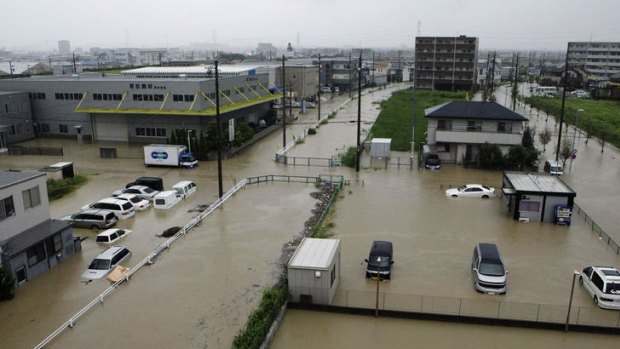 Vehicles sit submerged in floodwaters in Nagoya, Japan.