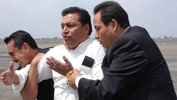 Surrender...the hijacker, a Bolivian preacher in custody.