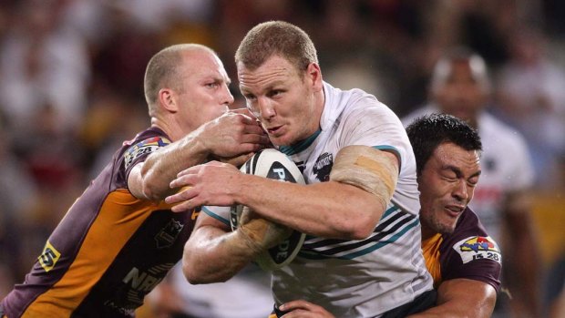 Luke Lewis takes on the Broncos defence.