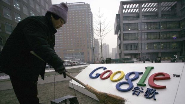 A cleaner sweeps the logo of Google China outside its company headquarters in Beijing.