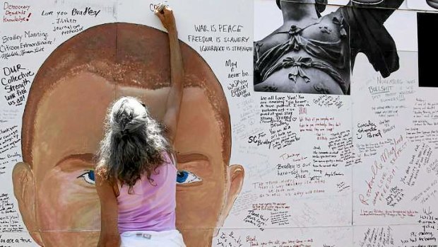 Democracy in action? A supporter signs a mural backing WikiLeaks leaker Private Bradley Manning.