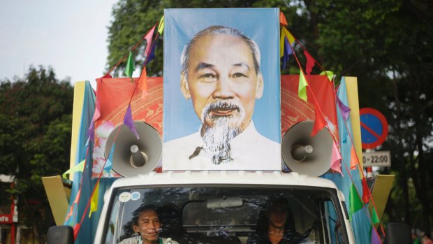 Vietnamese men in their truck decorated with a portrait of national hero Ho Chi Minh before a parade ahead of the celebration of the 40th anniversary of the end of the Vietnam War in Ho Chi Minh City, formerly known as Saigon.
