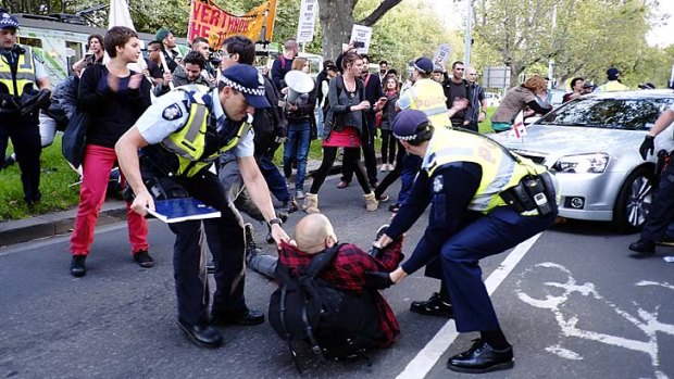 Protesters trying to stop Robert Doyle's car as it approaches the National Gallery of Victoria on Thursday.