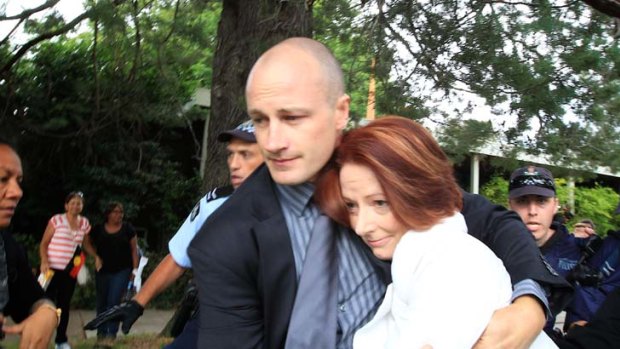 Prime Minister Julia Gillard and a member of her Close Personal Protection Team, Lucas.