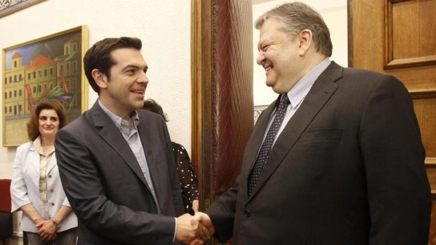 PASOK party leader Evangelos Venizelos (right) and Greece's Syriza party head Alexis Tsipras shake hands during their meeting at the Greek parliament.
