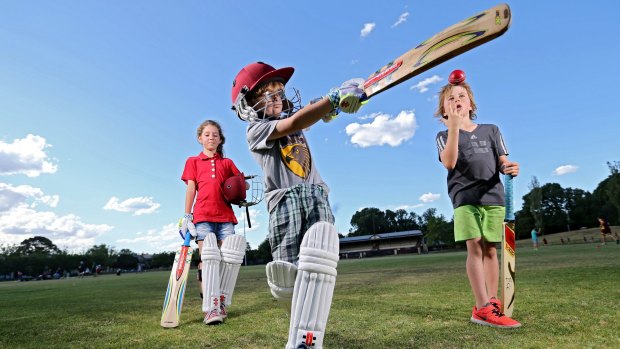 Edinburgh Cricket Club juniors Isabel Smith, Ted Smith and Freddie Cole for a photo at Brunswick Street Oval in Melbourne.