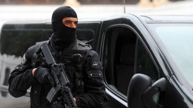 A member of the Tunisian President Security Force stands guard in front of the government Palace in the kasbah in Tunis.